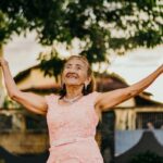 A woman raising her hands.