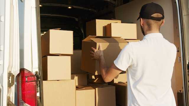 Professional mover unloading a van after an office relocation