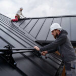 Workers roofing a house