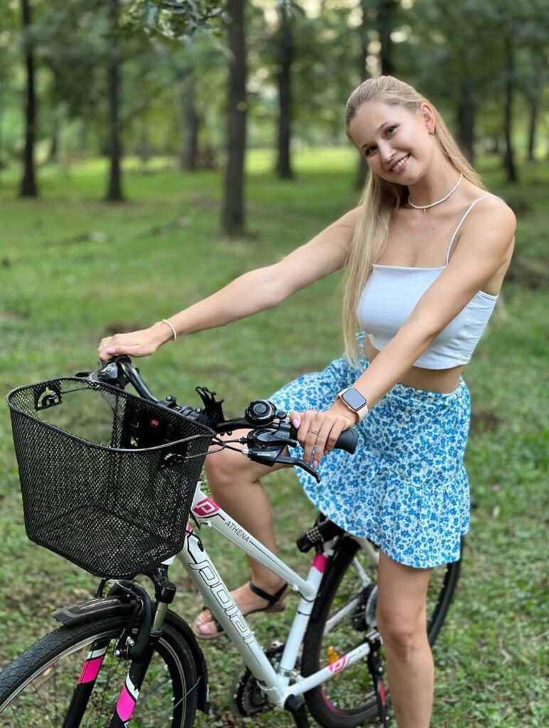 A photo of Stella Cardo sitting on a bicycle