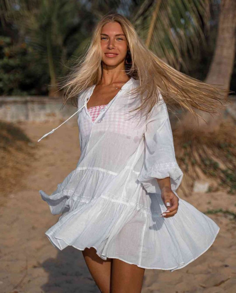 A photo of Anjelica Ebbi in white dress