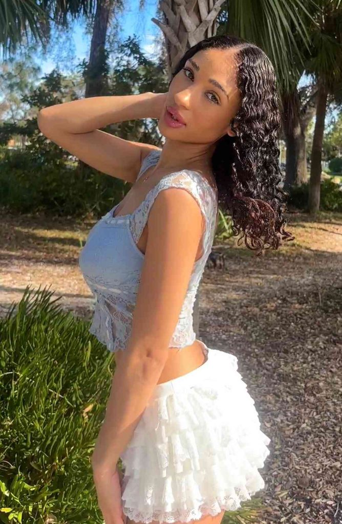 A photo of Lina Love in a white dress